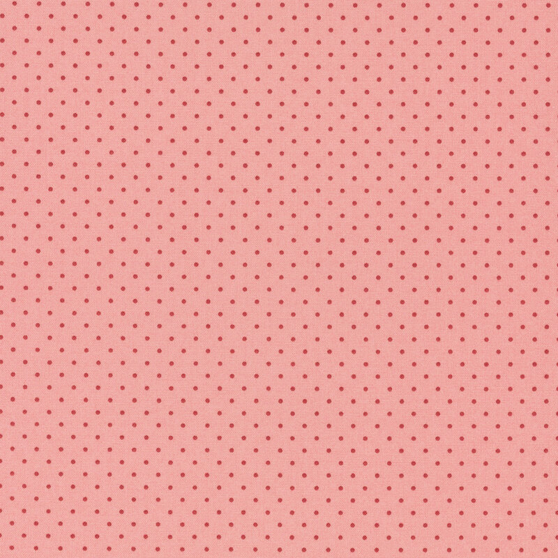 A pink fabric with evenly spaced dark pink polka dots.