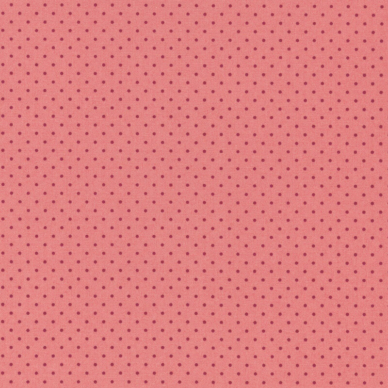 Pink fabric with evenly spaced, small dark red polka dots.