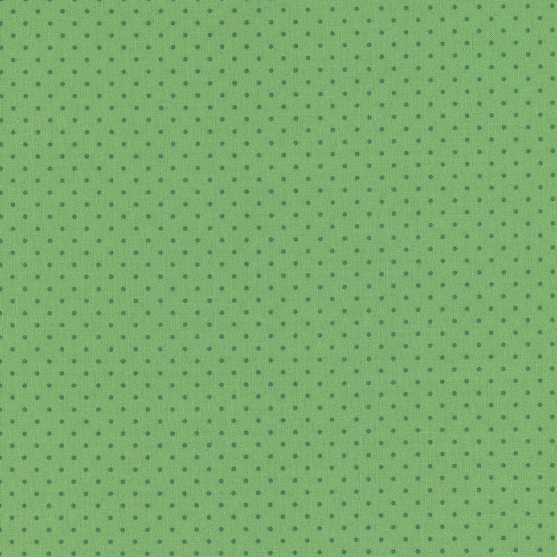 Green fabric with evenly spaced dark green polka dots.