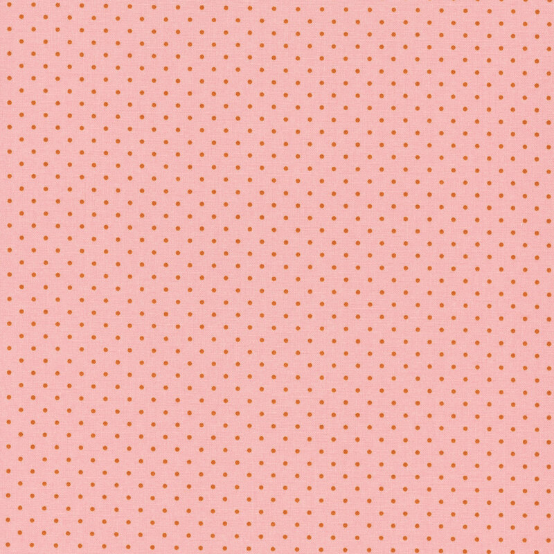 A light pink fabric with evenly spaced, small orange dots.