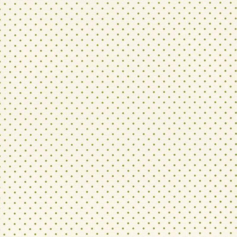 Cream fabric with a repeating pattern of small green dots.