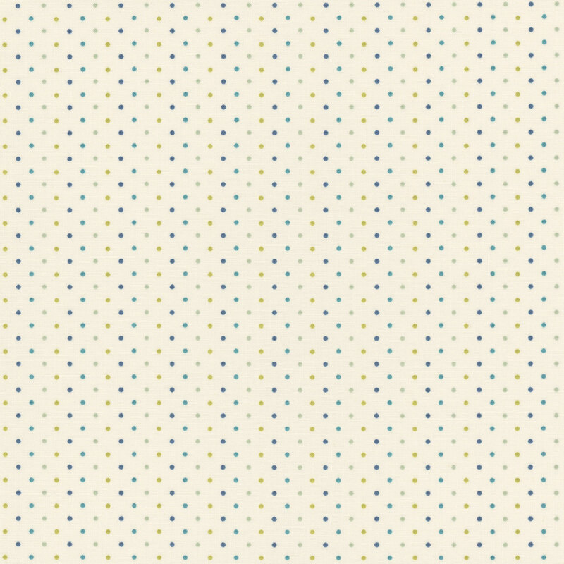 Patterned fabric featuring a scattered arrangement of green and blue dots on a light cream background.