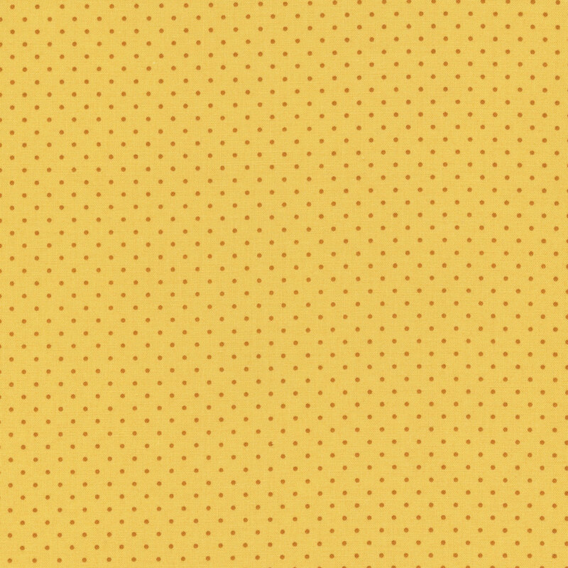A yellow fabric with a pattern of small orange polka dots.