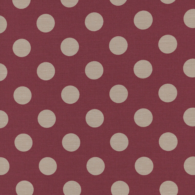 Burgundy fabric with light beige polka dots.