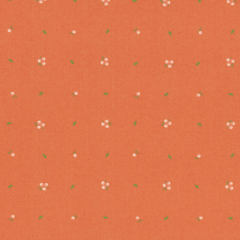 A textured orange fabric with small white flowers and green leaves scattered throughout.