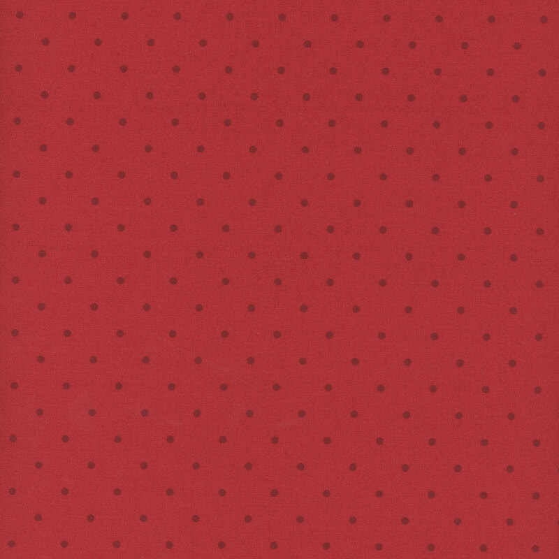 Red fabric with a tonal red polka dot pattern.