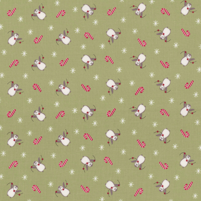 Green fabric pattern featuring playful white and gray penguins, red candy canes, and white stars.