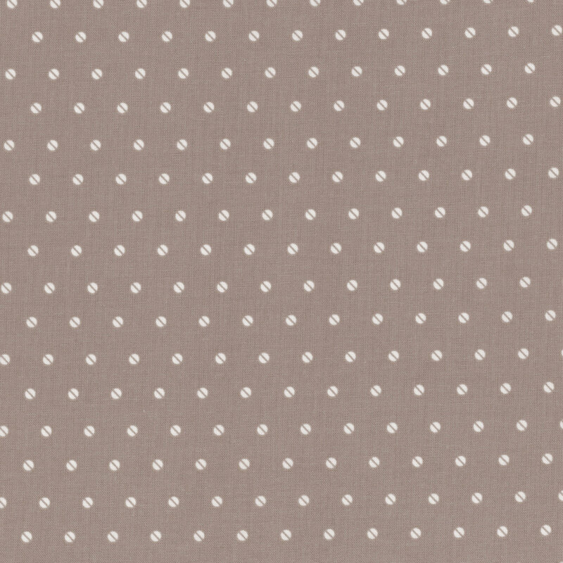 Taupe fabric featuring a regular pattern of small white polka dots.