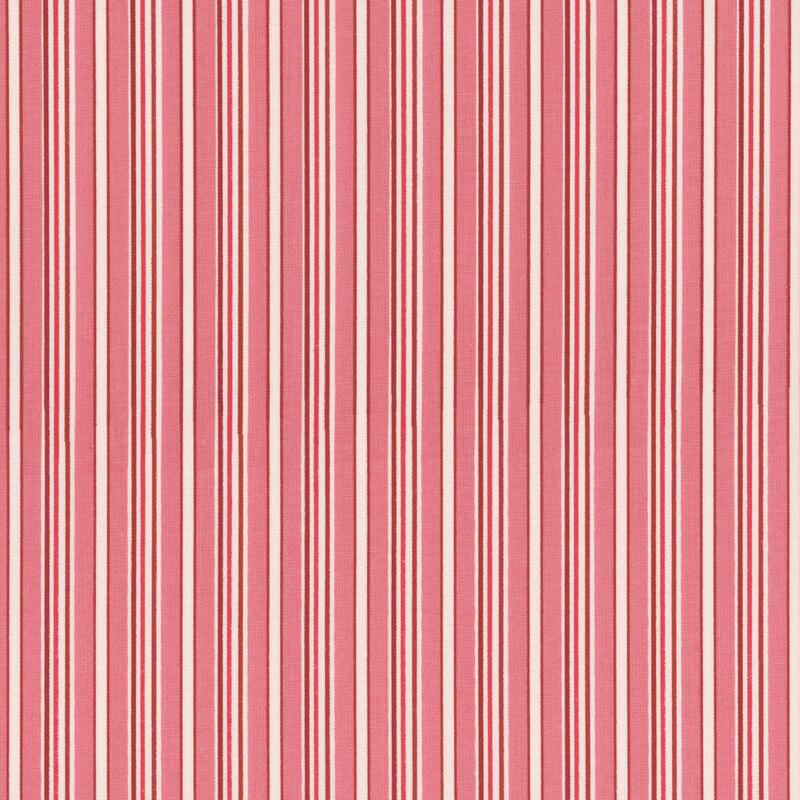 Close-up of a pink fabric with alternating thin and thick white stripes.