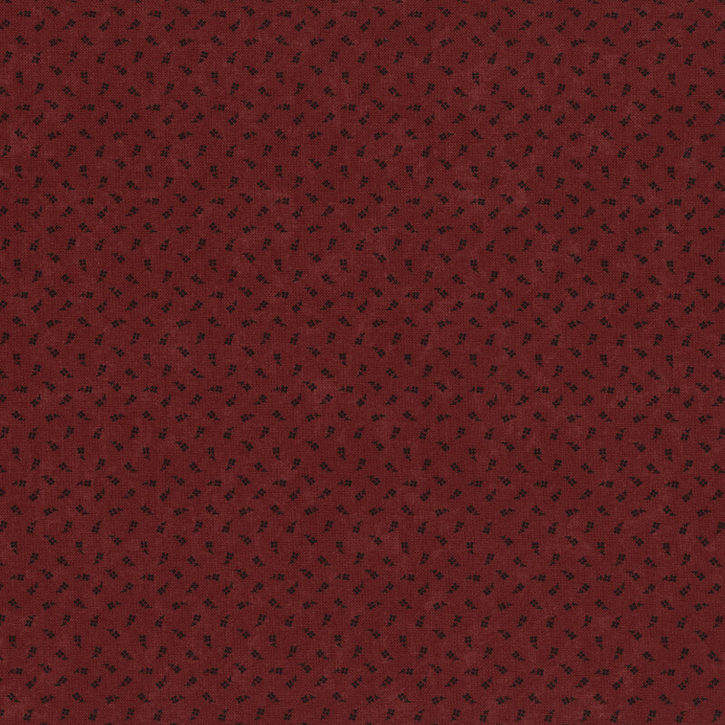 Textured deep red fabric with a subtle black pattern of small, scattered shapes.