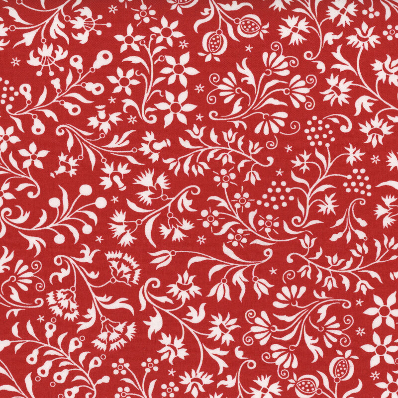 Red fabric with white twisting, ornamental leaf and flower designs.