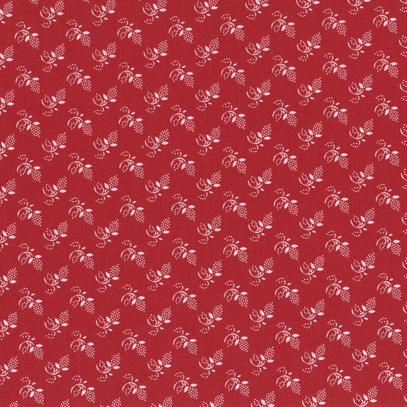 Red fabric with tonal sprigs and dotted buds.