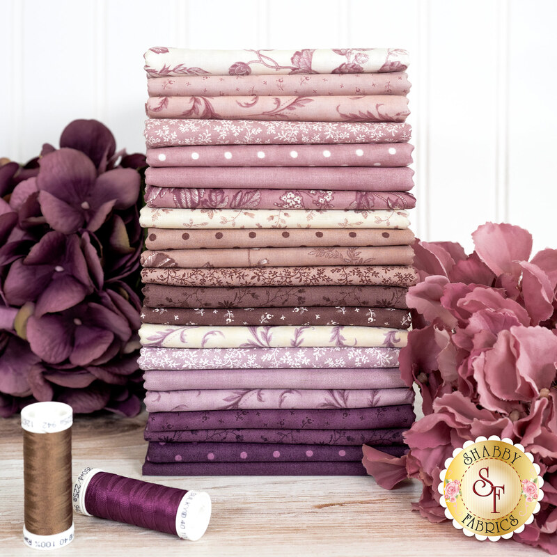 A stack of the Lavender Fields FQ bundle, with flowers and thread.