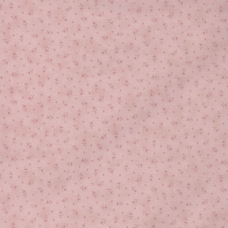 Light pink fabric featuring a pattern of small floral motifs