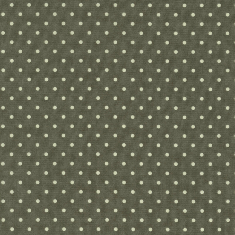 Dark green fabric with a repeating pattern of small white polka dots.