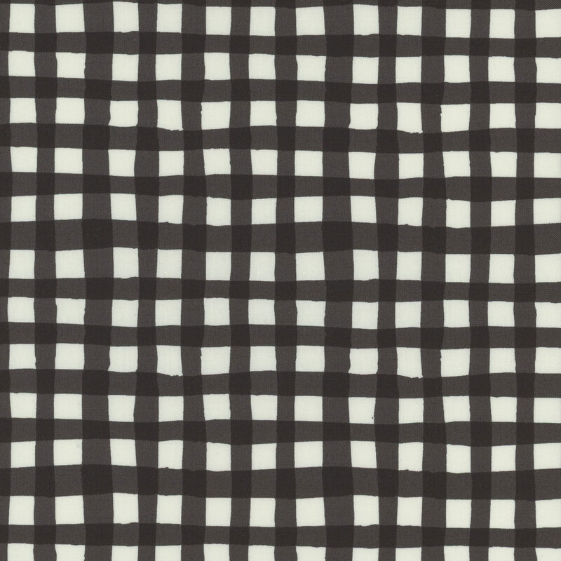 Black and white checkered fabric with alternating squares arranged in a grid.