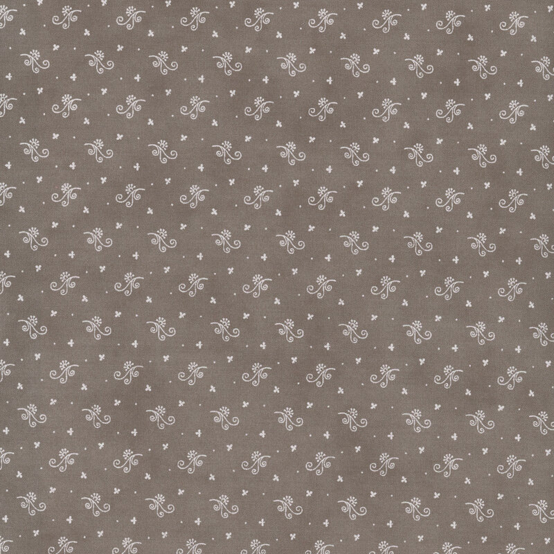 A mottled fabric pattern featuring small white floral designs on a muted brown background.