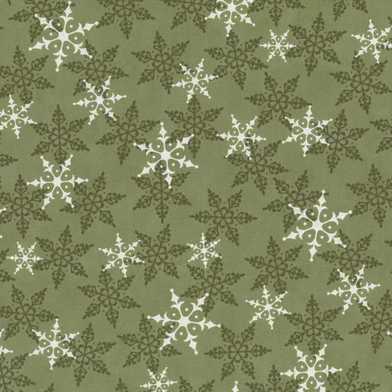 Green fabric with white and tonal snowflakes tossed across the design.