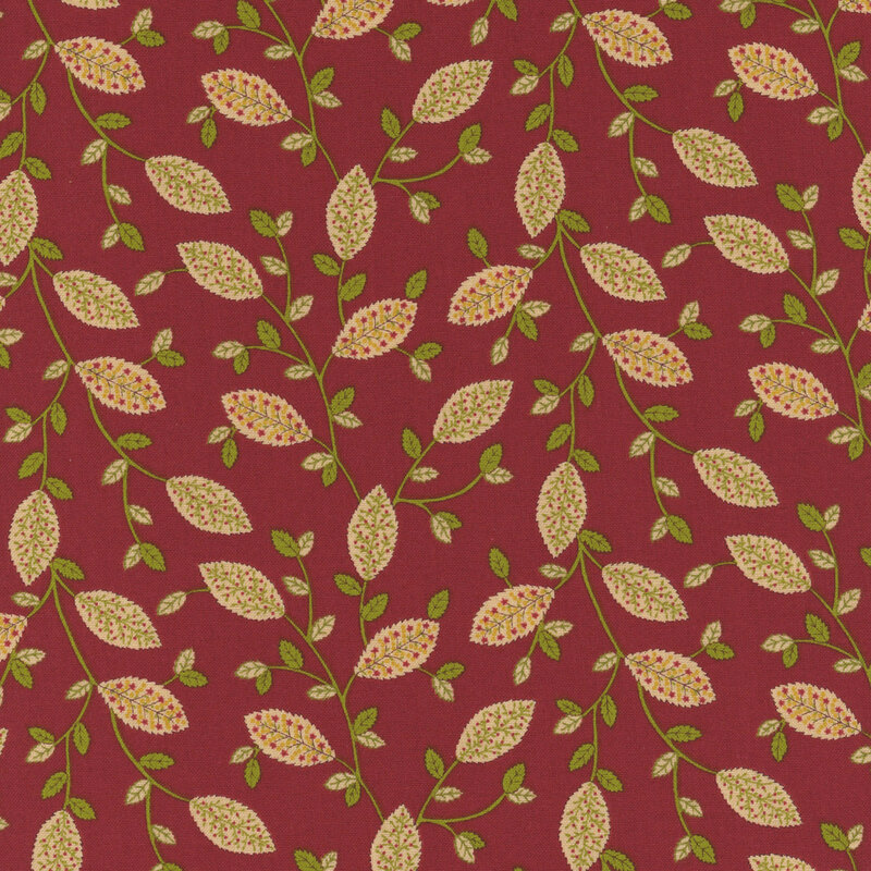 Red fabric with a repeating pattern of light green leaves and small flowers on dark stems.
