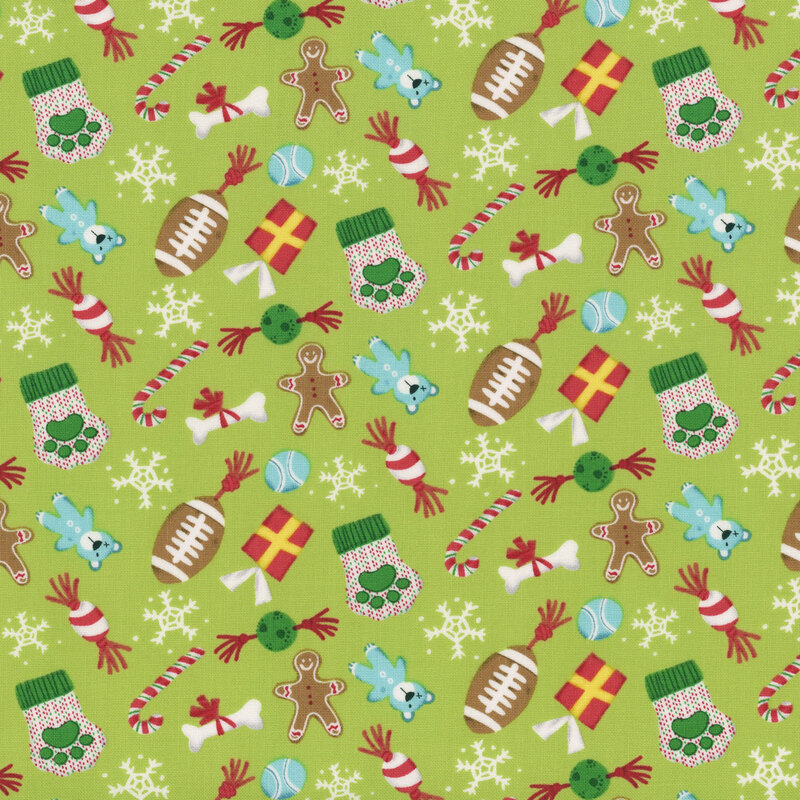 Pattern of festive holiday items including stockings, candy canes, toys, and snowflakes on a green background.