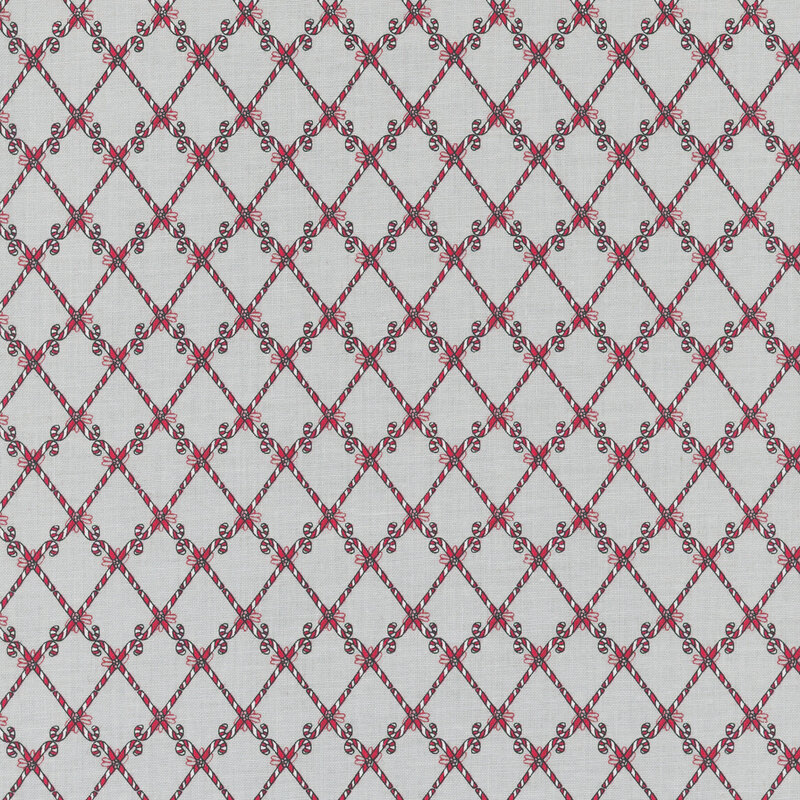 Textile pattern featuring a diamond grid design with red floral motifs on a light background.