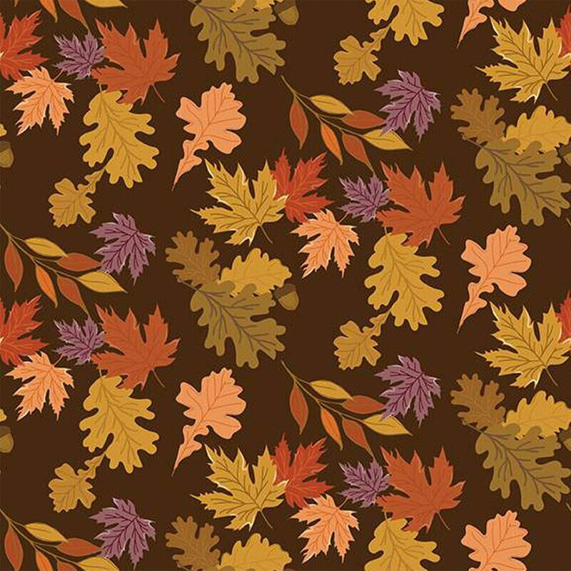 Fabric with colorful autumn leaves in various shapes scattered on a dark brown background.