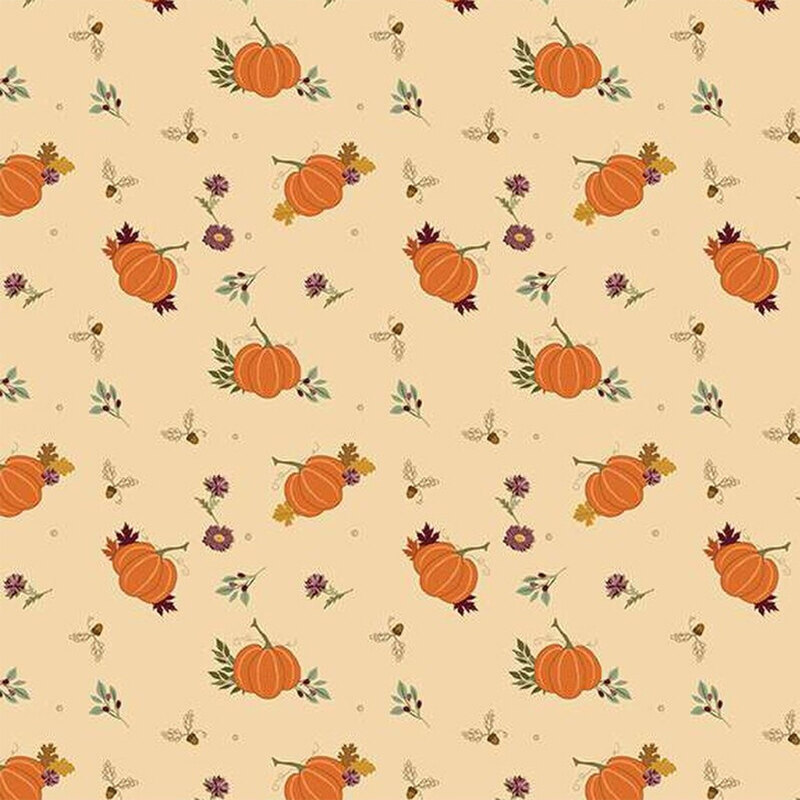 Fabric with pumpkins and wildflowers on a light beige background.