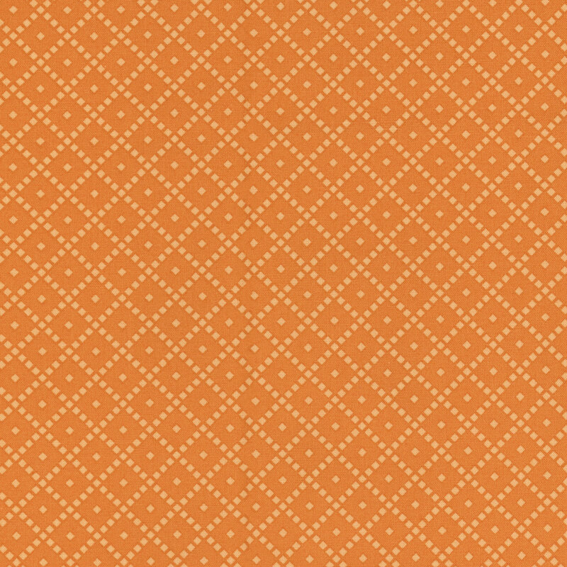 Fabric featuring an orange background with a diamond pattern and small light-colored dots.