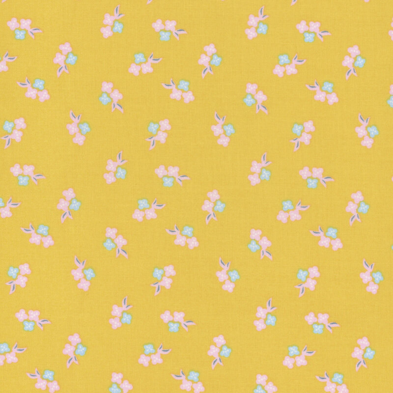 A yellow background fabric pattern with small pink and blue flowers and green leaves.