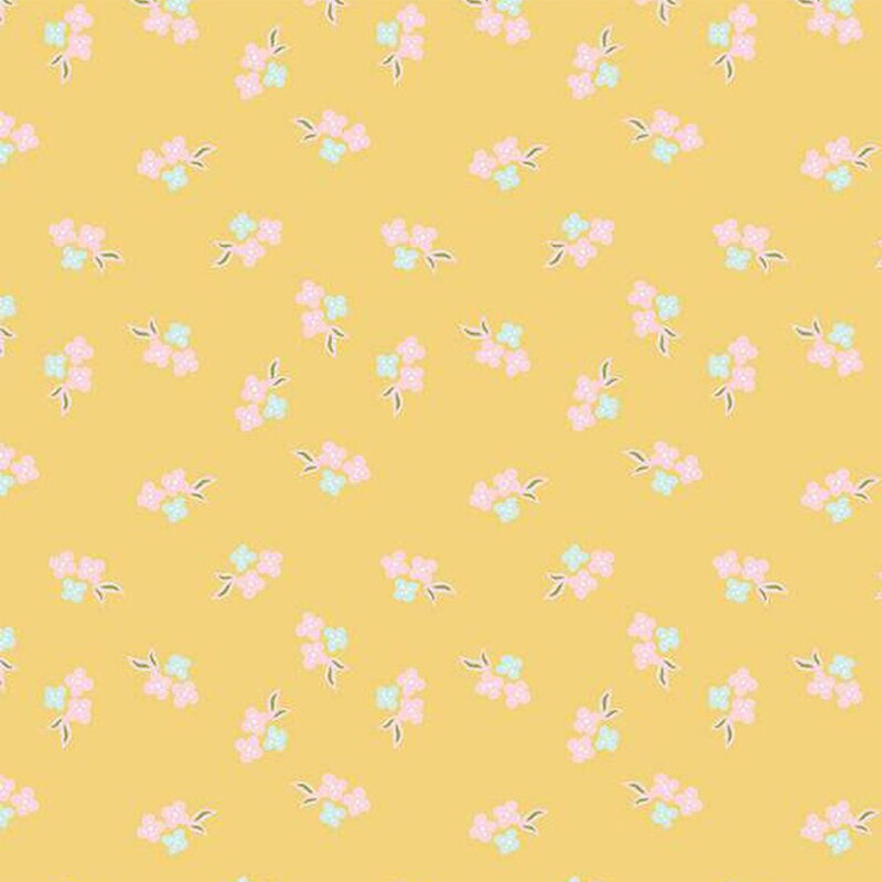 A yellow background fabric pattern with small pink and blue flowers and green leaves.