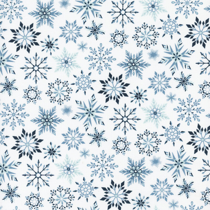 White fabric featuring various snowflakes in shades of blue.