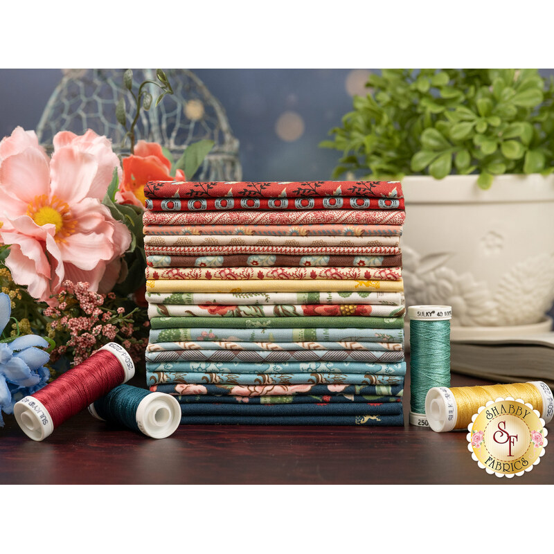 A stack of the fabrics included in the Emma collection, with flowers and plants and a pot and a birdcage and thread.
