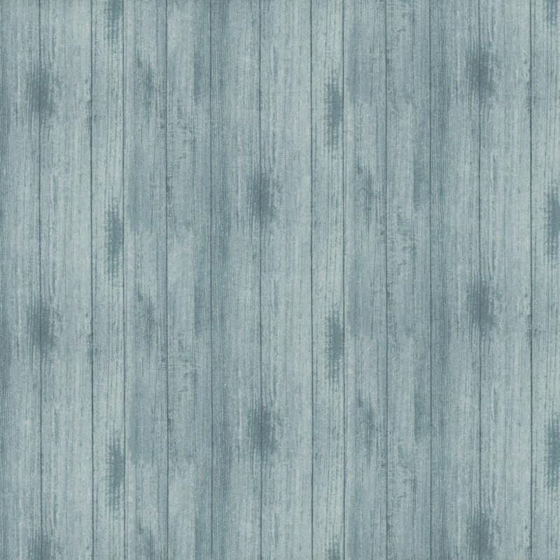 Gray blue wooden paneling with a textured, weathered appearance and vertical grain patterns.