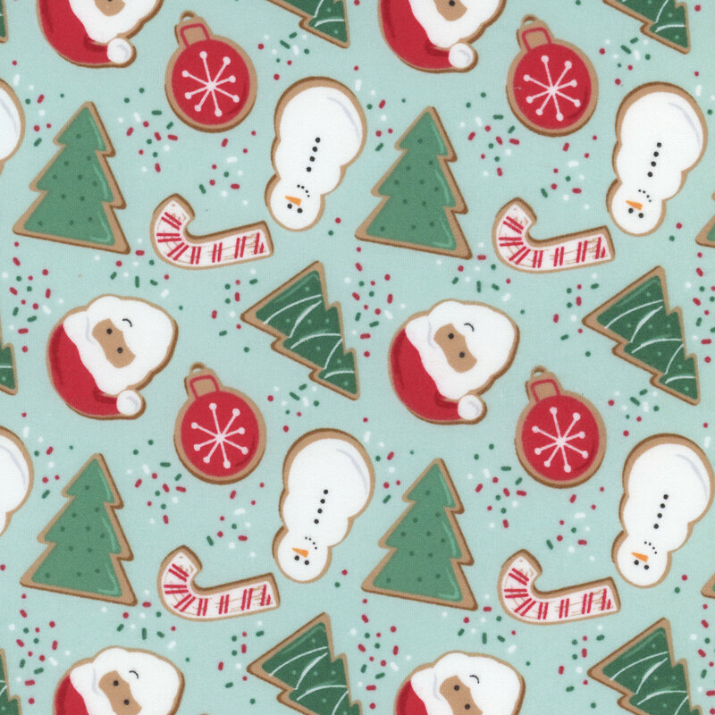 Mint fabric featuring gingerbread cookies that look like pine trees, candy canes, ornaments, snowmen, and Santa Claus