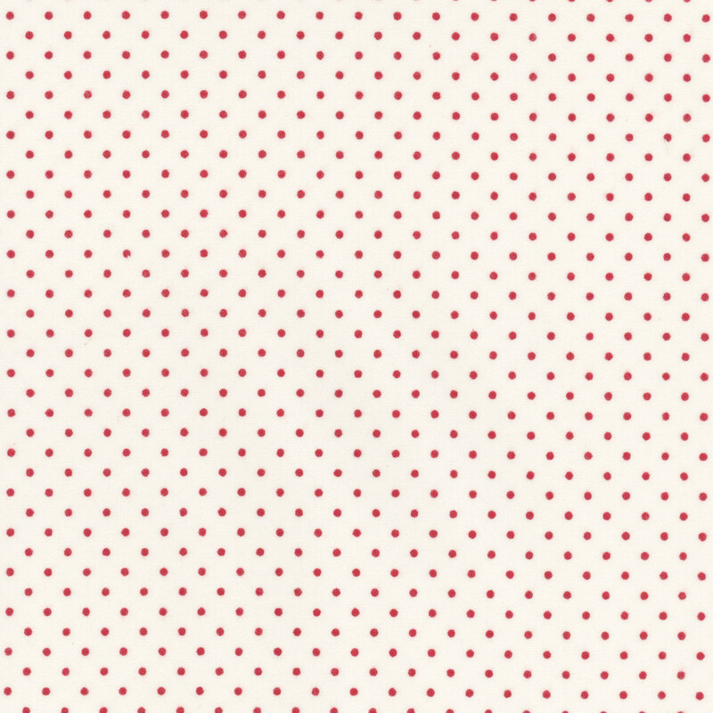 White fabric featuring small red polka dots throughout