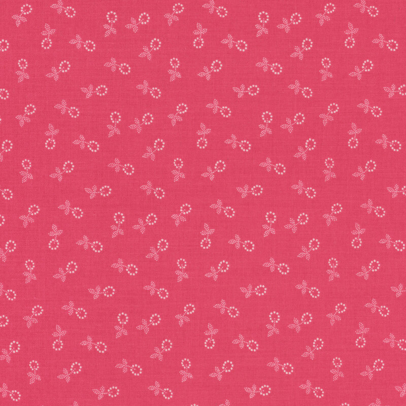 Fabric featuring a calico pattern of small white flower blossoms on a pink background.