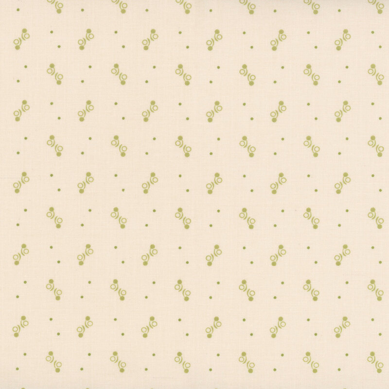 Light beige fabric with a repeating pattern of green leaves and small dots.
