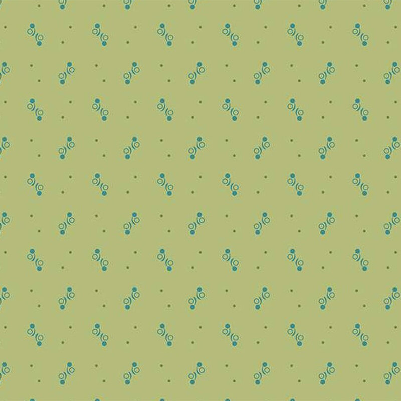 Fabric featuring small blue dotted shapes on a light green backdrop.