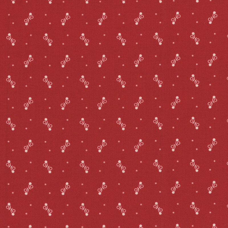 Red fabric featuring small white dotted designs throughout.