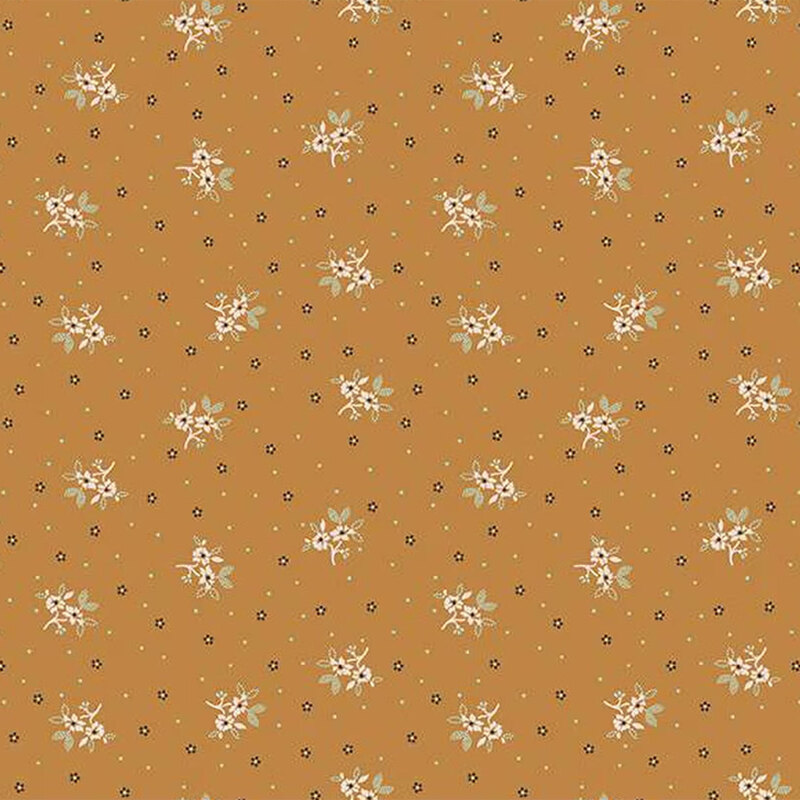 A warm orange fabric background with scattered small white floral patterns and black dots.