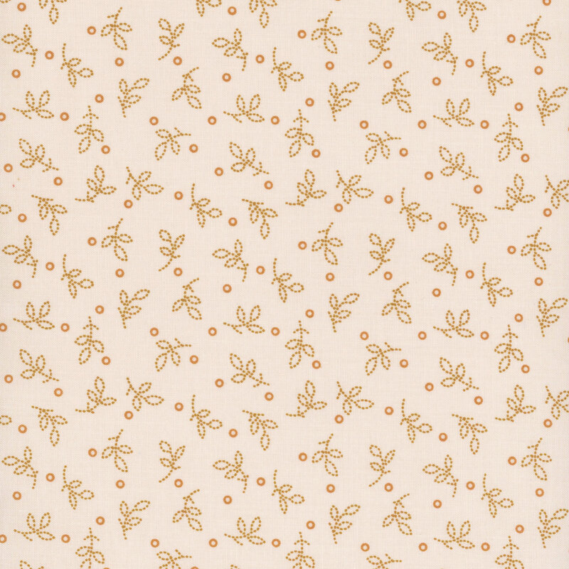Fabric with small golden leaves and circles on a light beige background.