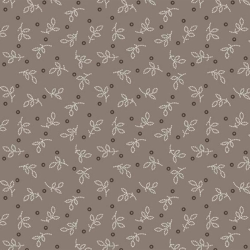 Gray brown fabric featuring scattered white leaves and small dark circles.