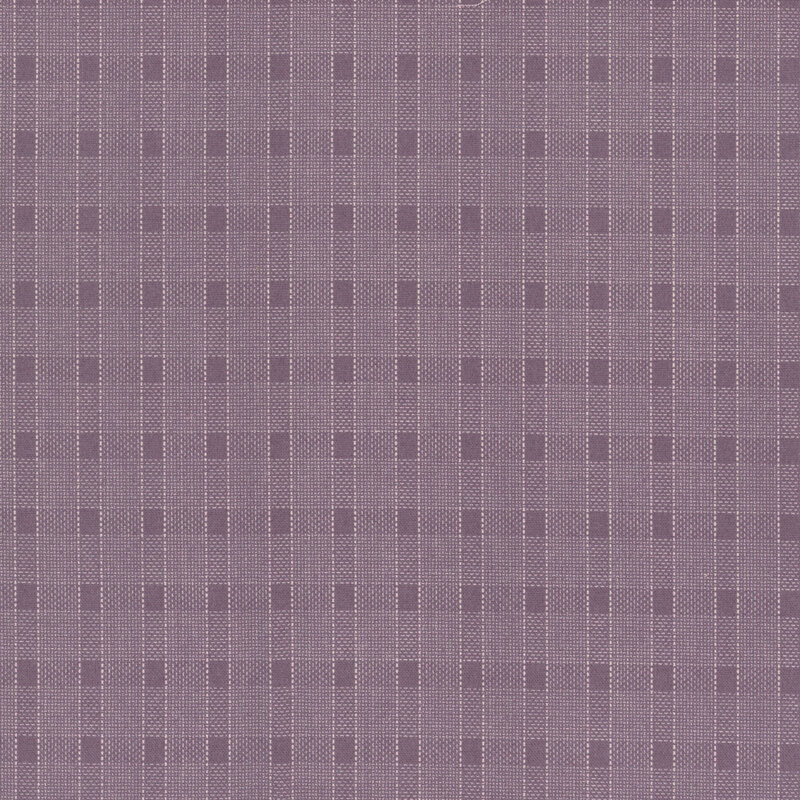 Fabric with a purple plaid design with thin white lines.