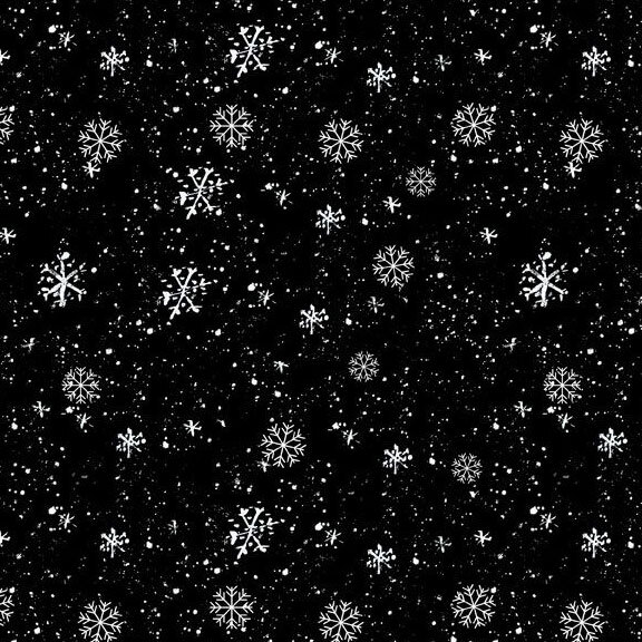 White snowflakes of various sizes scattered across a black fabric.