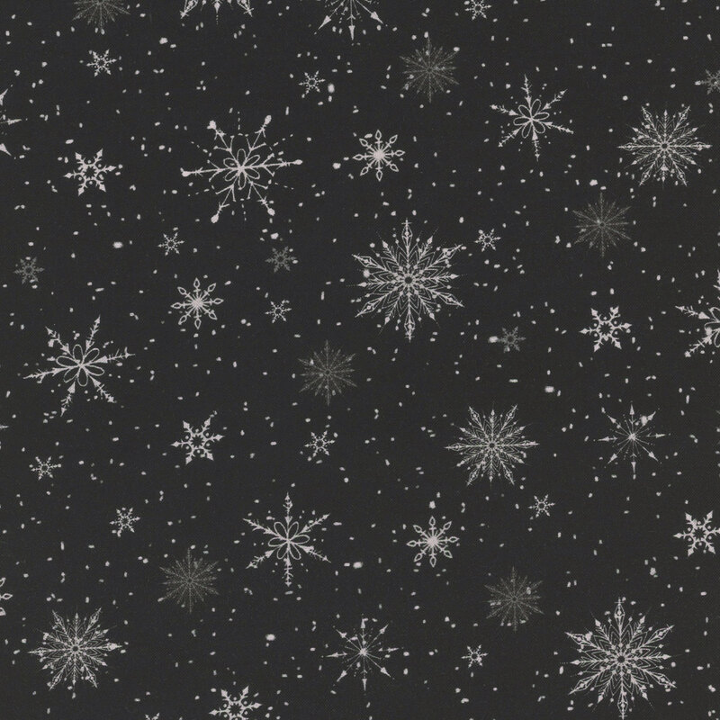 Black fabric with various sized unique snowflakes on a pinprick starry background.