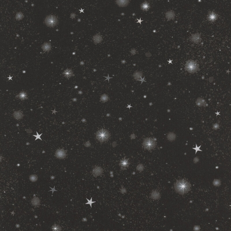 Black fabric with tossed stars and blurry circles of light on a textured background.