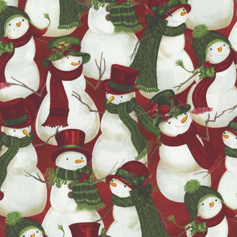 A fabric featuring a winter pattern of snowmen wearing hats and scarves, adorned with winter greenery.