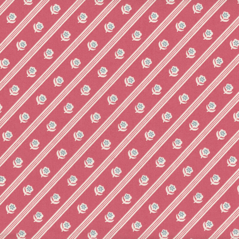 Pink fabric with white and slate blue florals in diagonal stripes.