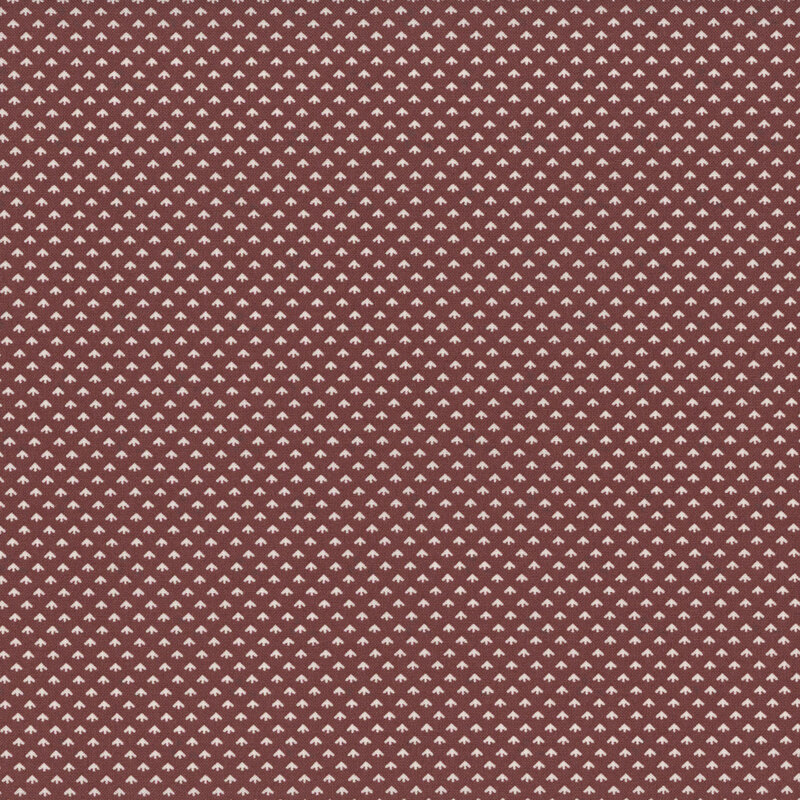 Fabric with tiny white florets on a dark purplish brown background.