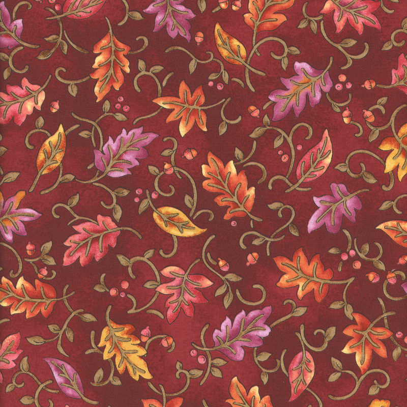 A rich burgundy fabric featuring a decorative pattern of colorful autumn leaves and swirls.